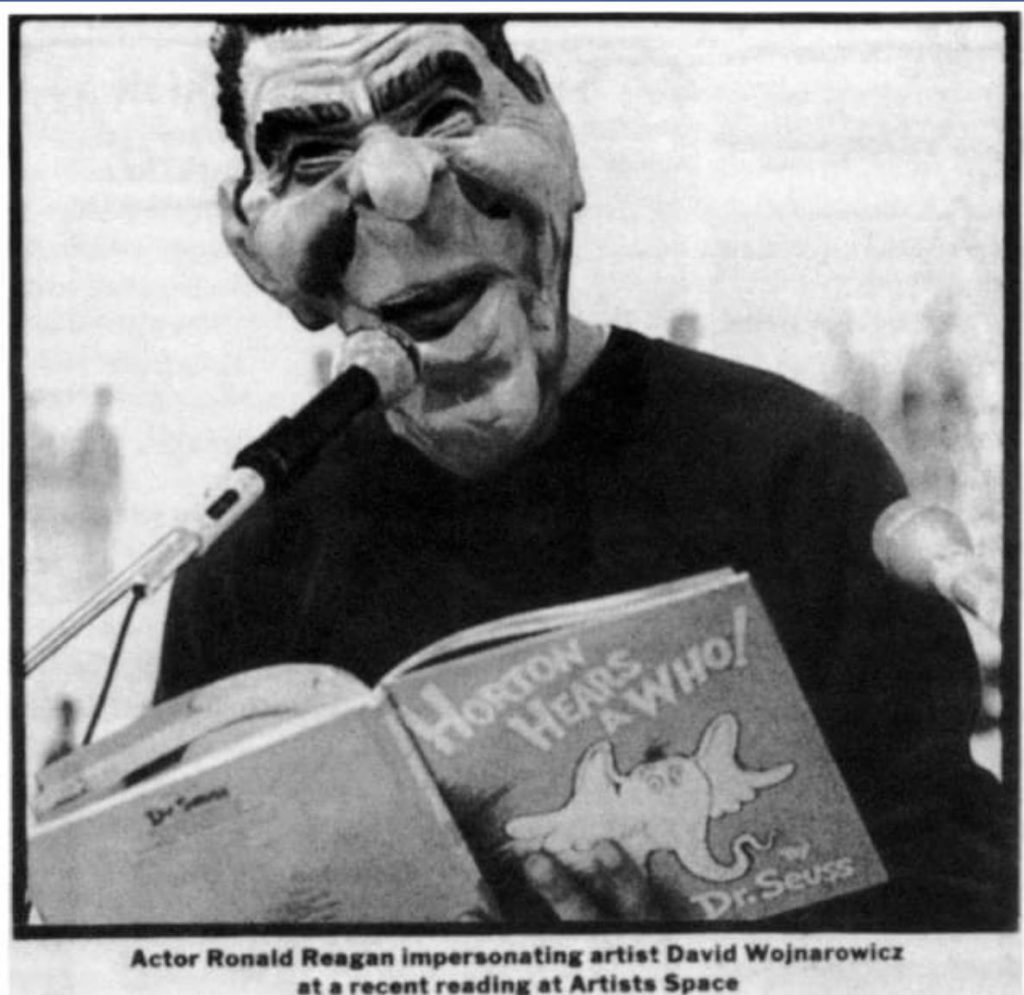 David Wojnarowicz in Ronald Reagan mask reading Dr. Seuss' "Horton Hears a Who!" at exhibition "Witness: Against Our Vanishing", organized by Nan Goldin, on November 29, 1989. Artists Space, New York City. Photo courtesy of Thomas McGovern. (Activism : Performance)