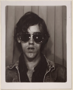 Self portrait in photo booth with aviators from The David Wojnarowicz Papers courtesy The Downtown Collection Fales Library and Special Collections, New York University.