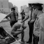 Andreas Sterzing, Bill Downer Sculpture Being "Arrested" during Pier 34 raid, June 1983. Photo copyright and courtesy Andreas Sterzing.