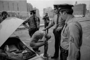 Andreas Sterzing, Bill Downer Sculpture Being "Arrested" during Pier 34 raid, June 1983. Photo copyright and courtesy Andreas Sterzing.