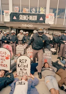 David Wojnarowicz holding tombstone at October 11, 1988 ACT UP "Seize Control of the FDA," protest. Photo copyright and courtesy J. Scott Applewhite.