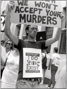 David Wojnarowicz demonstrates with ACT UP outside the offices of the NYC Commissioner of Health. Photograph copyright and courtesy t.l. litt.
