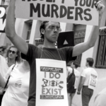 David Wojnarowicz demonstrates with ACT UP outside the offices of the NYC Commissioner of Health. Photograph copyright and courtesy t.l. litt.